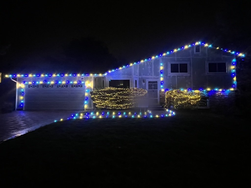 Roofline lighting on a home at night